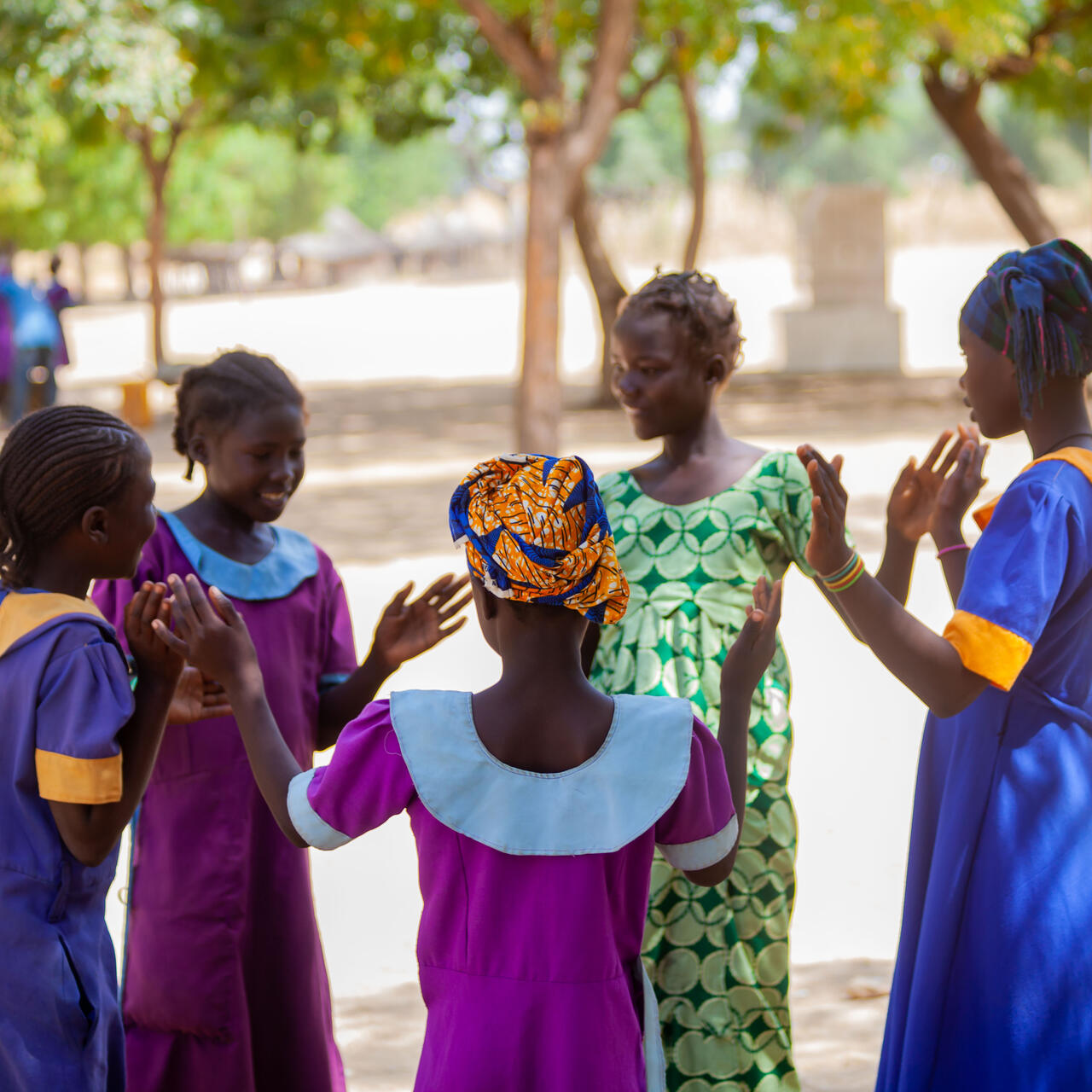 Oudjila, Cameroon. Wedé Clémautine, 12, Asta Julienne, 14 and some of their classmates having fun in the school playground.